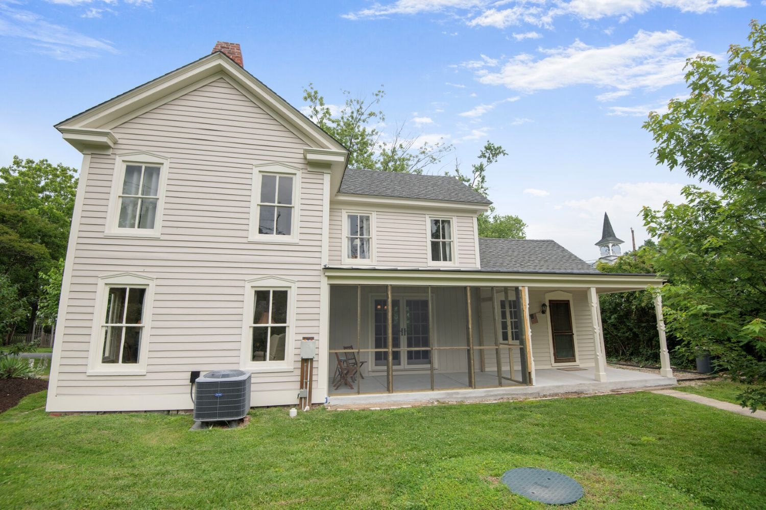 The stepped massing flows to a porch featuring screened and open sections for seamless indoor-outdoor living.